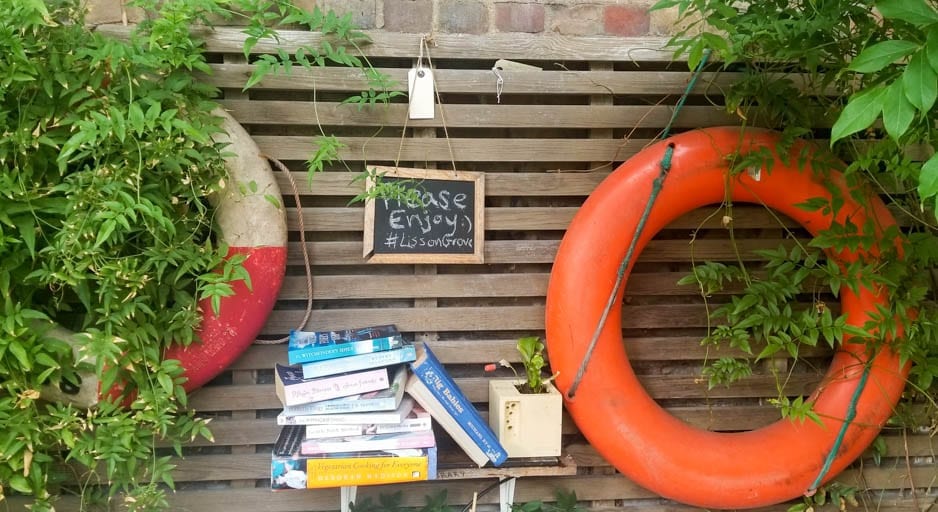 Little Venice London where houseboat residents swap books alongside the canal walk in London