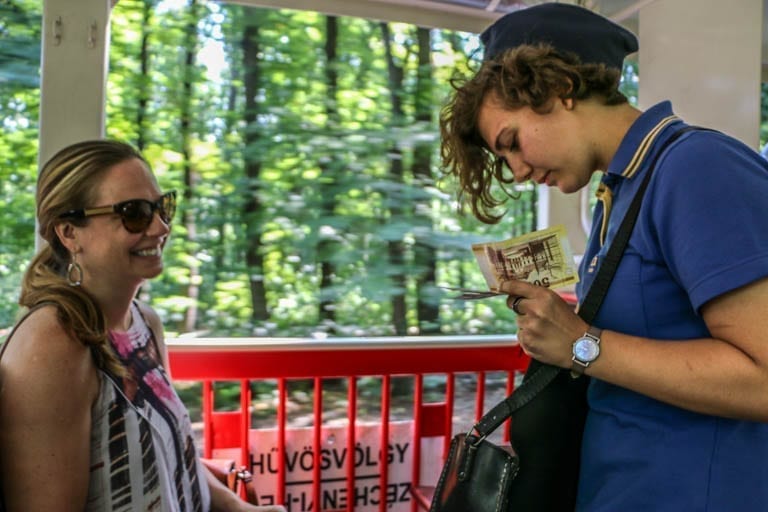 Paying the fare to a conductor on the Children's Railway in Budapest