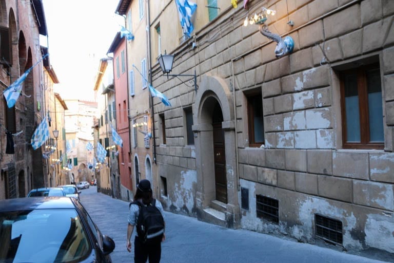 A Siena street with flags waviing