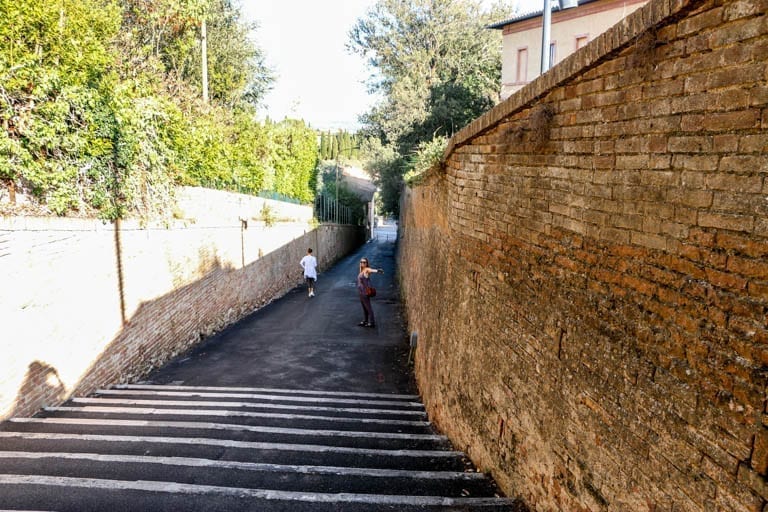 Hill leading out of the medieval gate of Siena, Italy.