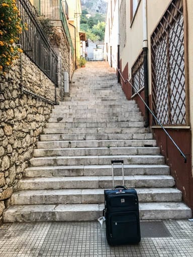 Suitcase at the base of the stairs