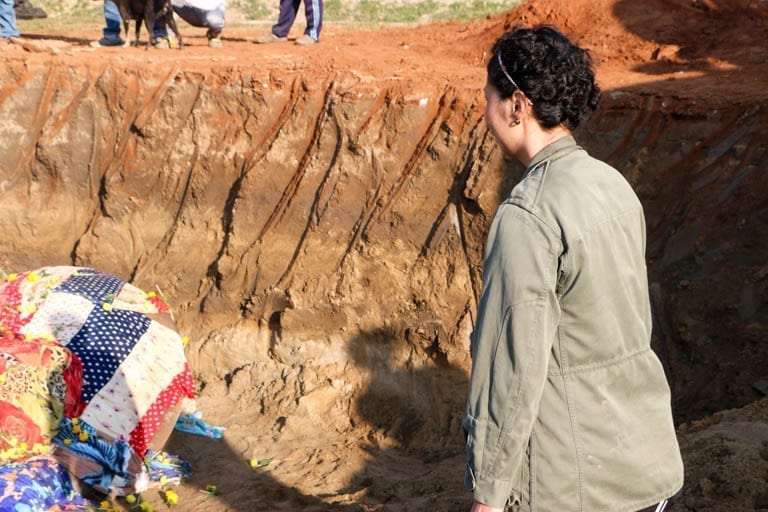 Throwing flowers on an elephant grave at an ethical elephant sanctuary in Thailand