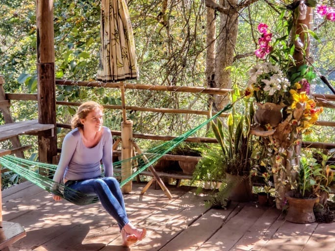 A guest lounges in a hammock at the Cave Lodge in Thailand