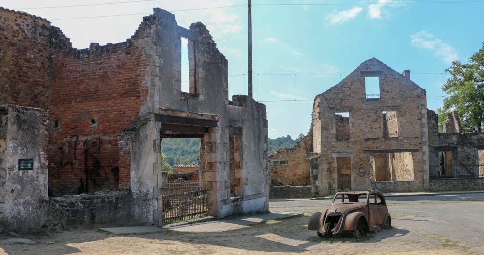 A burned out car and building in the martyr village of France, serve as a reminder of what happened at Oradour-sur-Glane