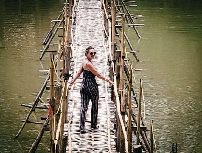 Crossing a bamboo bridge in Luang Prabang. It's the perfect place to make a wish in Southeast Asia.