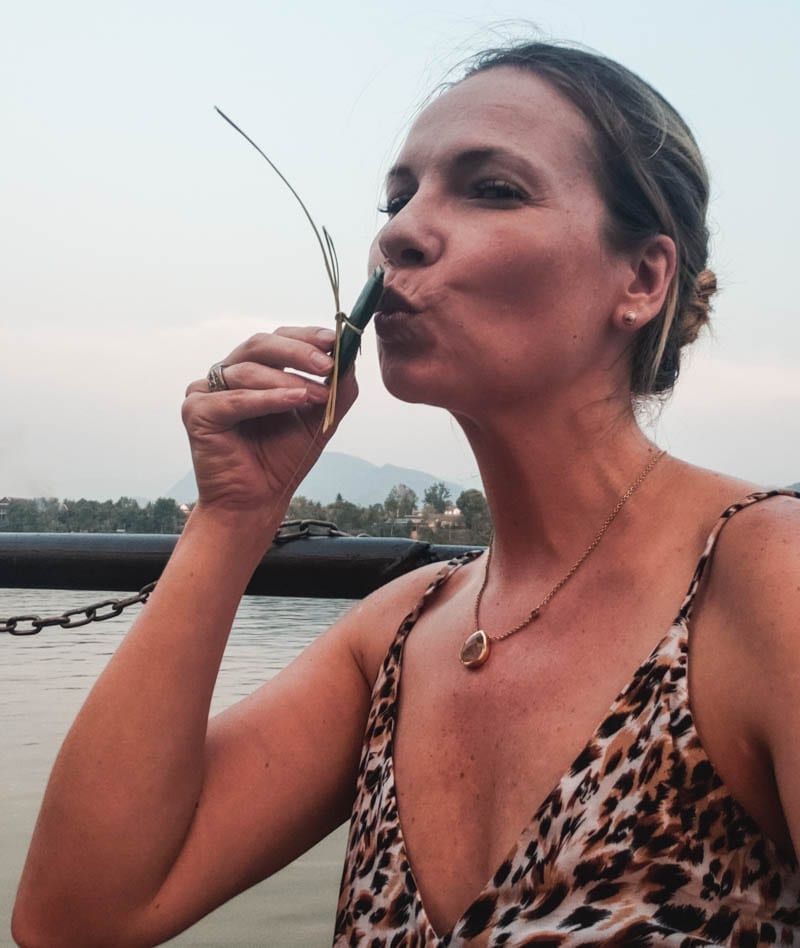 Making a wish in Southeast Asia on bamboo leaves to be released into the Mekong River.