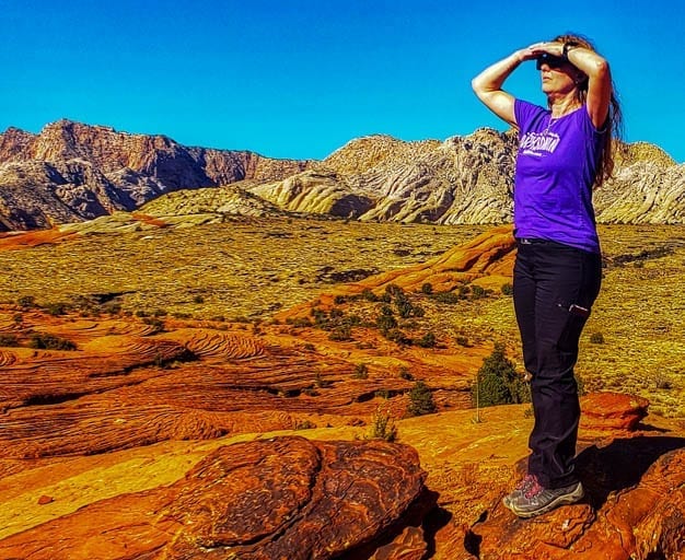 Woman gazes out at snow canyon state park