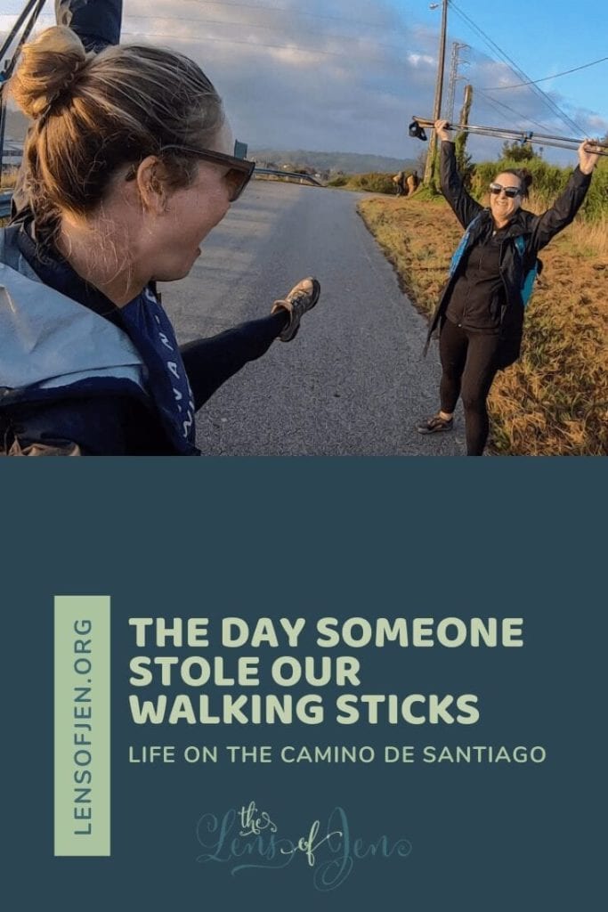 Two women hold walking sticks over head on the Camino del Norte