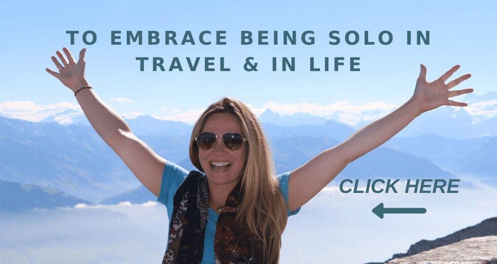 Solo Woman on a Mountaintop with triumphant arms up