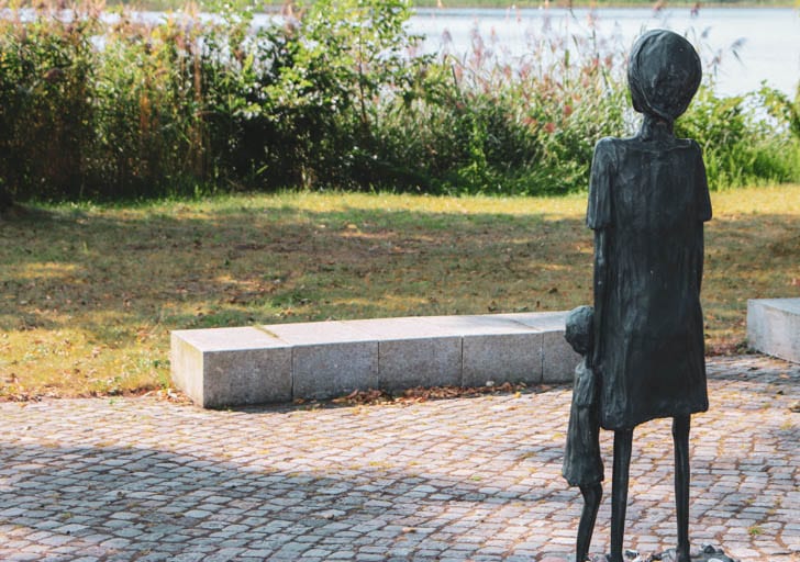 A statue of a woman with a child at the Ravensbrück Concentration Camp Memorial