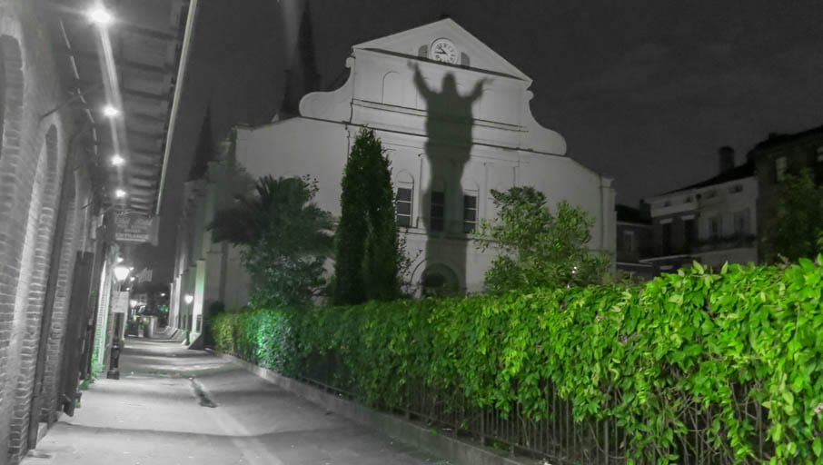 the dark history of New Orleans on display with the evening shadow of Touchdown Jesus.