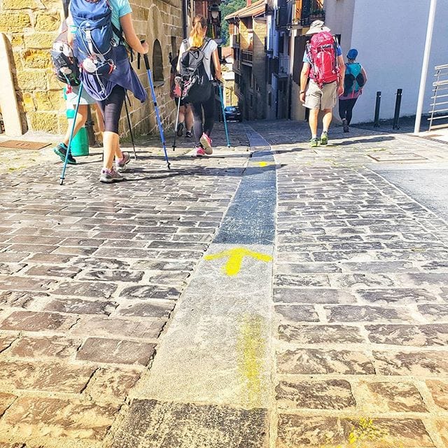 Yellow Arrow painted on the street along the Camino del Norte