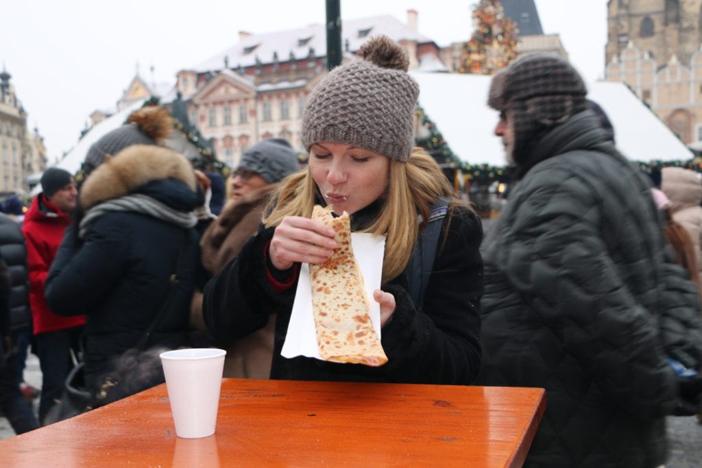 eating in a crowded outdoor market in Prague