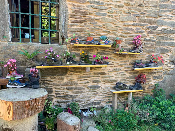 boots on a wall near santiago on the camino de santiago