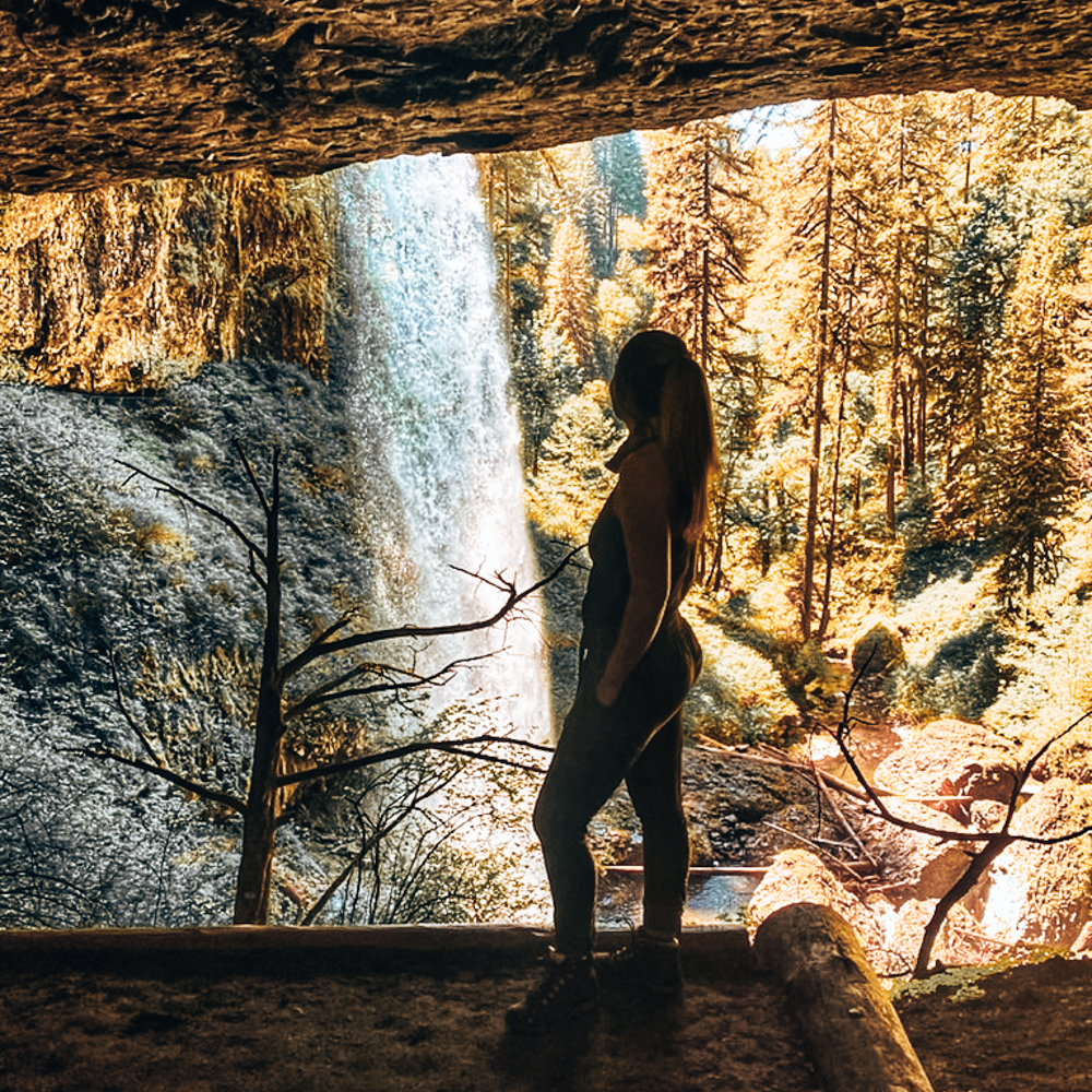 woman standing behind north falls on the trail of ten falls