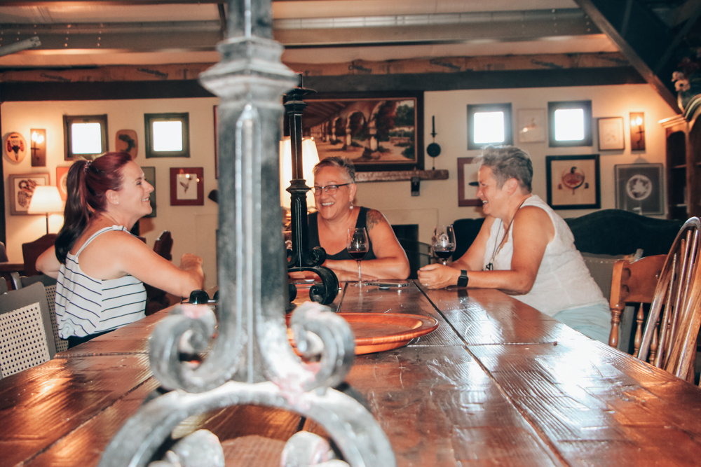 People laugh over the long table at Hatfield Creek Vineyards, one of the Ramona wineries